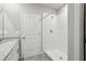 Modern bathroom featuring a walk-in shower with white tile surround, granite vanity, and neutral gray tile flooring at 3824 Radiant Mountain Dr, Plant City, FL 33565