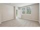 Bright bedroom featuring neutral carpeting, and a door leading to the exterior at 3824 Radiant Mountain Dr, Plant City, FL 33565