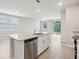 Kitchen island with stainless steel dishwasher overlooking the patio doors and back yard at 3824 Radiant Mountain Dr, Plant City, FL 33565