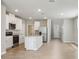 Modern kitchen with white cabinets, stainless steel appliances, and a breakfast bar island at 3824 Radiant Mountain Dr, Plant City, FL 33565