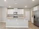Kitchen features stainless steel appliances, granite counters and an island with bar seating at 3824 Radiant Mountain Dr, Plant City, FL 33565