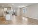 Open-concept living space with tile flooring, kitchen island, and abundant natural light at 3824 Radiant Mountain Dr, Plant City, FL 33565
