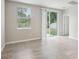 Bright living space featuring tiled floors, a window, and sliding glass door to the backyard at 3824 Radiant Mountain Dr, Plant City, FL 33565