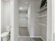 Walk-in closet with extensive shelving adjacent to a bathroom at 3824 Radiant Mountain Dr, Plant City, FL 33565