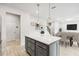 Stylish kitchen island with a white countertop, gray cabinets, and pendant lighting above at 12963 Brookside Moss Dr, Riverview, FL 33579