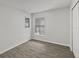 The bedroom offers neutral walls, two windows and modern flooring at 5211 Mango Fruit St, Seffner, FL 33584