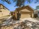 Charming single-story home featuring a two-car garage and manicured landscaping at 5211 Mango Fruit St, Seffner, FL 33584