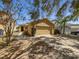 Inviting single-story home featuring a two-car garage and well-maintained front yard at 5211 Mango Fruit St, Seffner, FL 33584