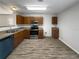 Bright kitchen with wood cabinets, stainless steel appliances, and modern flooring at 5211 Mango Fruit St, Seffner, FL 33584