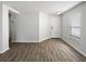 Open-concept living room with hardwood floors, ample light, and fresh neutral paint at 5211 Mango Fruit St, Seffner, FL 33584