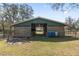 Exterior view of a barn featuring a green accent roof and open-air stall design at 3634 Apfel Rd, Wesley Chapel, FL 33543