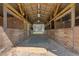 Clean barn interior showcasing individual stalls and a clear view to the exterior at 3634 Apfel Rd, Wesley Chapel, FL 33543