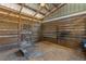 Rustic barn interior featuring exposed wood beams, wood slat walls, and natural light at 3634 Apfel Rd, Wesley Chapel, FL 33543