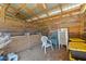 Spacious barn interior with a wood slat wall, metal roof, and organized storage at 3634 Apfel Rd, Wesley Chapel, FL 33543