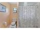Bathroom featuring a shower and peach colored walls at 3634 Apfel Rd, Wesley Chapel, FL 33543