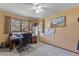 Bedroom featuring desk, carpet, windows, and neutral walls for lots of natural light at 3634 Apfel Rd, Wesley Chapel, FL 33543