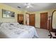 Bedroom with ceiling fan, neutral walls, and built-in storage solutions at 3634 Apfel Rd, Wesley Chapel, FL 33543