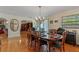 Formal dining room with wood table, chairs, chandelier, and natural light at 3634 Apfel Rd, Wesley Chapel, FL 33543