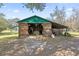 Large workshop space with open doors for ventilation, equipped with storage, and workbench at 3634 Apfel Rd, Wesley Chapel, FL 33543