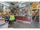 Garage featuring ample storage space, organized tools, and vintage decor at 3634 Apfel Rd, Wesley Chapel, FL 33543