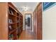 Hallway features hardwood floors, built-in bookshelves and multiple storage closets at 3634 Apfel Rd, Wesley Chapel, FL 33543