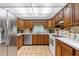 Traditional kitchen with wood cabinets, white countertops, and stainless steel appliances at 3634 Apfel Rd, Wesley Chapel, FL 33543