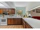 Bright kitchen featuring tile floors, white counters, and a garden view at 3634 Apfel Rd, Wesley Chapel, FL 33543