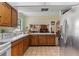 Kitchen with white countertops, tile floors and view to living room with fireplace at 3634 Apfel Rd, Wesley Chapel, FL 33543