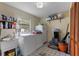 Bright laundry room with washer, dryer, shelving, storage, and tile flooring at 3634 Apfel Rd, Wesley Chapel, FL 33543