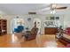 Spacious living room with hardwood floors and views to the kitchen and dining area at 3634 Apfel Rd, Wesley Chapel, FL 33543