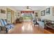 Open-plan living room featuring hardwood floors, comfortable seating, and natural light at 3634 Apfel Rd, Wesley Chapel, FL 33543