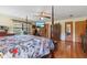 Bright main bedroom with a four-poster bed, ensuite access, and decorative touches at 3634 Apfel Rd, Wesley Chapel, FL 33543