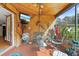 Cozy screened porch offering space to relax with mounted TV and wood paneling at 3634 Apfel Rd, Wesley Chapel, FL 33543