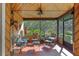 Relaxing screened porch with comfortable seating and views of the lush yard at 3634 Apfel Rd, Wesley Chapel, FL 33543