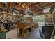 Functional workshop with organized storage, workbench, and roll-up door for easy access at 3634 Apfel Rd, Wesley Chapel, FL 33543