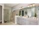 A spacious bathroom showcasing double sinks, modern fixtures, and a glass enclosed shower at 6243 Plateau Ct, Bradenton, FL 34203