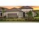Charming single Gathering home featuring desert landscaping, a tile roof, and an attached two-car garage at 6243 Plateau Ct, Bradenton, FL 34203