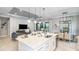 Open-concept kitchen with a large island, a dining area, and a comfortable living room in a bright and airy space at 6243 Plateau Ct, Bradenton, FL 34203