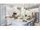 Modern gourmet kitchen featuring white cabinets, a quartz island, stainless steel appliances, and pendant lighting at 6243 Plateau Ct, Bradenton, FL 34203