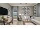 Stylish home office with a neutral color palette, plush sofa, herringbone floors, and modern accents at 6243 Plateau Ct, Bradenton, FL 34203