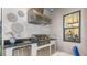 Outdoor kitchen area featuring a stainless steel grill, vent hood, mini fridge, and granite countertops at 6243 Plateau Ct, Bradenton, FL 34203