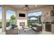 Relax in this outdoor living space with a fireplace, comfortable seating, and scenic lake views at 6243 Plateau Ct, Bradenton, FL 34203