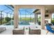 Inviting screened-in pool and patio area with scenic lake views at 6243 Plateau Ct, Bradenton, FL 34203