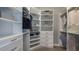 An organized walk-in closet with custom shelving and drawers for optimal storage solutions at 6243 Plateau Ct, Bradenton, FL 34203