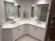 Bathroom vanity featuring dual sinks, modern fixtures, and cabinet storage for a clean and functional space at 8111 Lakewood Main St # 207, Lakewood Ranch, FL 34202