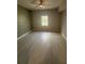 Bedroom with tiled floors and view of community landscaping from window at 8111 Lakewood Main St # 207, Lakewood Ranch, FL 34202