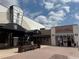 Exterior view of commercial building with a movie theater and a sports pub under a partly cloudy sky at 8111 Lakewood Main St # 207, Lakewood Ranch, FL 34202