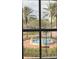View of fountain and tropical palms seen through the living room window at 8111 Lakewood Main St # 207, Lakewood Ranch, FL 34202