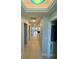 Hallway featuring tile floors, lighting, and doorways at 8111 Lakewood Main St # 207, Lakewood Ranch, FL 34202