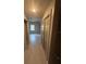 Hallway with tiled floors, closet space, and entrance to the living room at 8111 Lakewood Main St # 207, Lakewood Ranch, FL 34202